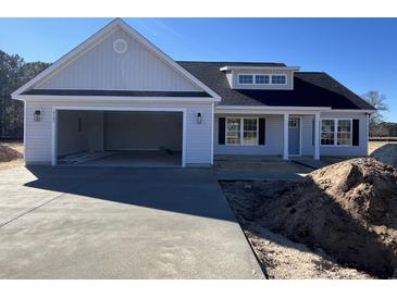 Newly constructed home with attached garage and neutral siding at 8187 Kerl Rd., Conway, SC 29526