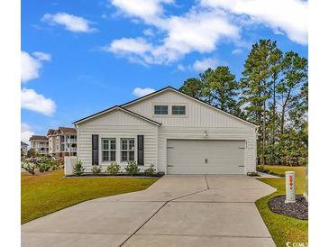 White house with gray shutters, two car garage, and landscaped lawn at 2015 Borgata Loop, Longs, SC 29568