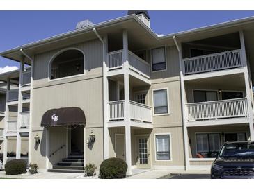 Multi-level condo building with well-kept exteriors, balconies, and visible entry awning at 4290 Pinehurst Circle # B6, Little River, SC 29566