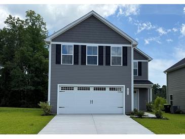 Two-story home featuring a two-car garage, black shutters, gray siding, and manicured landscaping at 1055 Oak Meadow Dr., Conway, SC 29526