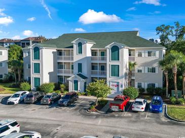 Multi-level condo building with ample parking, well-maintained landscaping, and attractive architectural details at 1100 Commons Blvd. # 104, Myrtle Beach, SC 29572