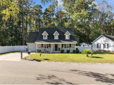 Attractive two-story house with a spacious lawn and a white fence at 118 Sly Fox Trail, Myrtle Beach, SC 29588