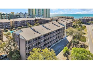 Scenic exterior view of a beachfront condo complex with stunning ocean views and lush landscaping at 212 2Nd Ave. N # 364, North Myrtle Beach, SC 29582