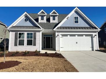 Two-story house with gray siding, white trim, and a two-car garage at 912 Anemone Ct Nw, Calabash, NC 28467