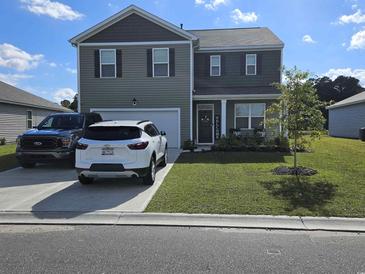 Two-story house with gray siding, a two-car garage, and a well-manicured lawn at 1098 Ridgeford Dr., Conway, SC 29526