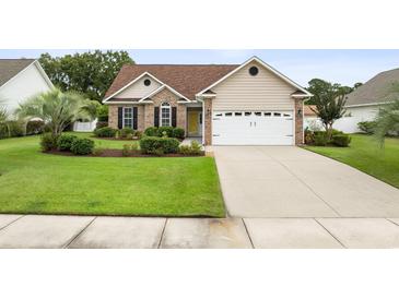 Brick and beige one-story house with a two-car garage and well-manicured lawn at 109 Pheasant Run Dr., Murrells Inlet, SC 29576