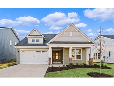 Charming single-Gathering home with a two-car garage and a beautifully landscaped front yard at 5032 Cambria Ct., Little River, SC 29566