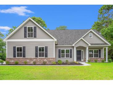 Charming one-story home with gray siding, brick accents, black shutters, and a well-manicured lawn at 2612 Old Charleston Rd., Georgetown, SC 29440