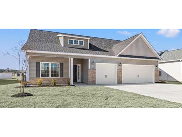 Charming home featuring gray siding, brick accents, and a convenient two-car garage at 299 Hayloft Circle, Conway, SC 29526