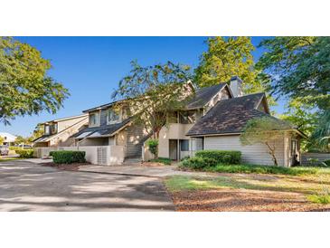 Attractive exterior of a two-story condo with mature trees and landscaping at 175 Saint Clears Way # 23-I, Myrtle Beach, SC 29572