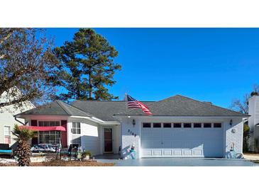 Charming single-story home with an attached garage and well-maintained lawn under a clear blue sky at 2169 Wedgewood Dr., Longs, SC 29568