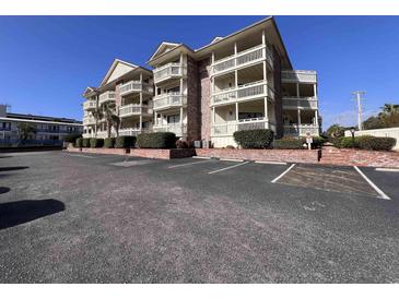 Spacious condo building featuring multiple balconies and ample parking at 2805 N Ocean Blvd. # 107, Myrtle Beach, SC 29577