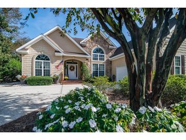 Charming home showcasing manicured landscaping and a welcoming front entrance at 1716 Club Circle Dr., Pawleys Island, SC 29585