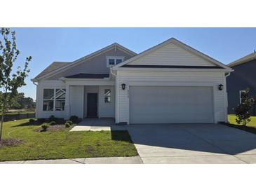 Charming new construction home featuring a two-car garage, landscaped front yard, and inviting entry at 8652 Farrier Dr., Myrtle Beach, SC 29588