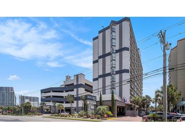 A multi-story condo complex featuring neutral toned exteriors with an attached parking deck at 5308 N Ocean Blvd. # 1014, Myrtle Beach, SC 29577
