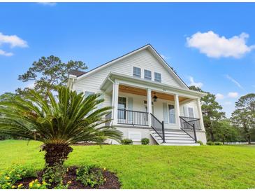 Inviting two-story home with a charming front porch and well-manicured lawn at 805 Comanders Island Rd., Georgetown, SC 29440