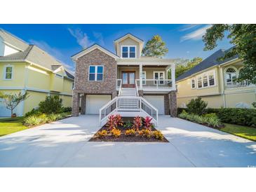Beautiful two-story home with a brick facade, double garage, and charming front porch at 1010 Club House Dr., North Myrtle Beach, SC 29582