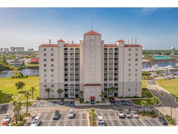 Stunning exterior view of building with red roof, multiple balconies, parking area, and gorgeous waterside views at 2151 Bridge View Ct. # 2502, North Myrtle Beach, SC 29582