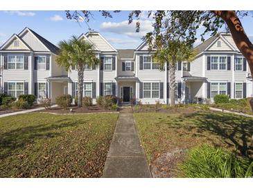 Inviting townhouse exterior with manicured lawn and palm trees adding curb appeal at 656 Pistoia Ln. # 304, Myrtle Beach, SC 29579
