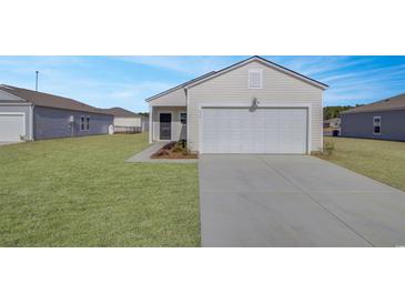 Inviting single-story home with a well-manicured lawn and a two-car garage at 246 Warner Crossing Way, Loris, SC 29569