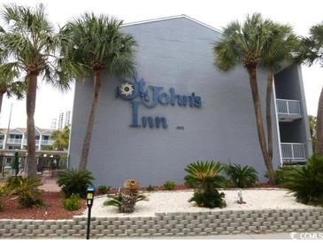 Facade of St. John's Inn building, displaying its signage and surrounding greenery at 6803 N Ocean Blvd. # 210, Myrtle Beach, SC 29572