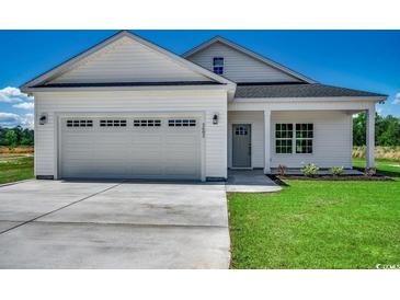 Charming single story home featuring an attached garage, green lawn, and traditional design elements at 2682 Hugo Rd., Conway, SC 29527