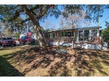 Charming single-story home with a large front yard, cozy porch, and mature tree with swing at 538 Calhoun Dr., Murrells Inlet, SC 29576