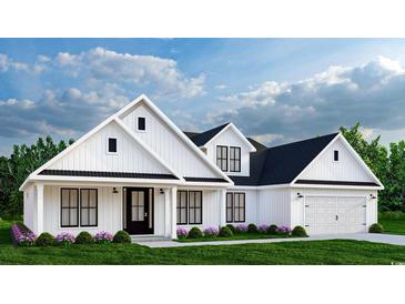Charming exterior of a modern farmhouse featuring white siding, black trim, and a well-manicured lawn at 681 Hawthorn Dr., Pawleys Island, SC 29585