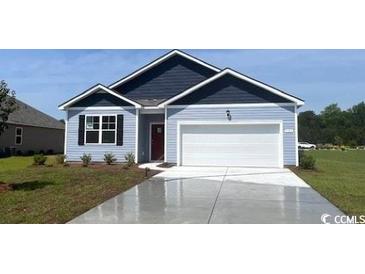 Charming single-story home featuring a two-car garage, a well-manicured lawn, and classic blue accents at 905 Farmers Passage Loop, Loris, SC 29569