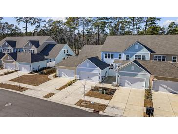 Aerial view of townhouses with attached garages and landscaping at 2523 Blue Crane Circle # 102, Myrtle Beach, SC 29577