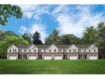 Front view of townhouses with brick facade and grassy lawn at 870 Foxtail Dr. # C-35, Longs, SC 29568