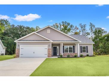 Newly constructed home with a two-car garage and a well-manicured lawn at 197 Six Mile Creek Dr., Georgetown, SC 29440