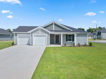 Charming single-story home with a two-car garage, well-maintained lawn, and inviting curb appeal at 1044 Kinness Dr., Conway, SC 29527