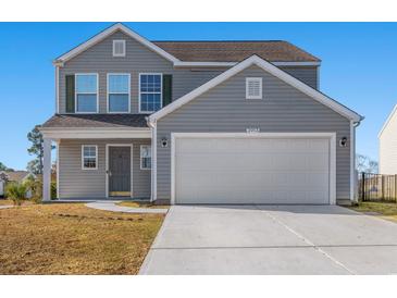 Charming two-story home featuring a two-car garage and well-maintained front yard on a sunny day at 2053 Haystack Way, Myrtle Beach, SC 29579