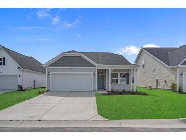Charming single-story home featuring a two-car garage, well-manicured lawn, and lovely curb appeal at 1200 Nw Calabash Station Blvd., Calabash, NC 28467