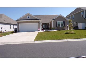 Charming single-Gathering home with a well-manicured lawn and a two-car garage at 3070 Sutherland Dr., Little River, SC 29566