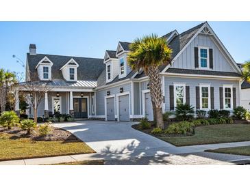 Beautiful two-story home with attached garage, lovely landscaping, and a welcoming front porch at 6105 Bolsena Place, Myrtle Beach, SC 29577