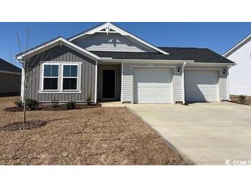 Charming one-story home featuring a two-car garage, classic architecture, and a well-maintained lawn at 1514 Clubstone Dr., Conway, SC 29526