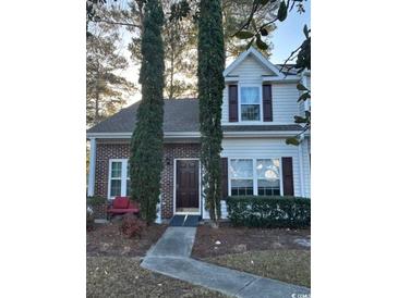 Two-story home with brick and vinyl siding, landscaping, and a paved walkway at 3517 Crepe Myrtle Ct. # 3517, Myrtle Beach, SC 29577