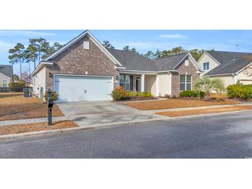 Charming single-story home featuring a brick facade, attached garage, and well-maintained front yard at 1139 Parish Way, Myrtle Beach, SC 29577