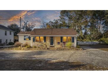 Charming bungalow exterior featuring a covered porch and well-maintained landscaping at 4502 Eyerly St., North Myrtle Beach, SC 29582