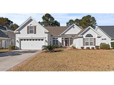 Charming one-story home featuring a manicured lawn, attached garage, and inviting front porch at 126 Pickering Dr., Murrells Inlet, SC 29576