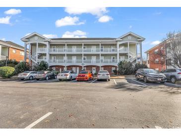 Inviting exterior of a multi-unit building with ample parking at 3943 Gladiola Ct. # 204, Myrtle Beach, SC 29588