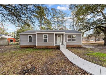 Charming single-story home featuring gray siding, white trim, and a welcoming front porch at 447 Bragdon Ave., Georgetown, SC 29440