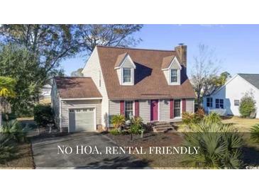 Charming two-story home featuring a well-manicured lawn, inviting curb appeal, and a cozy, classic design at 702 Plantation Dr., Surfside Beach, SC 29575