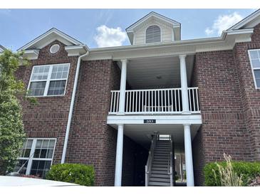 Brick building exterior with white columns and balcony at 2013 Silvercrest Dr. # 30-A, Myrtle Beach, SC 29579