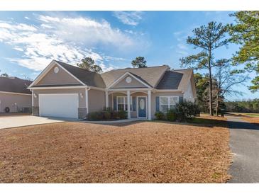 One-story house with a two-car garage and landscaped lawn at 363 Long Meadow Dr., Loris, SC 29569