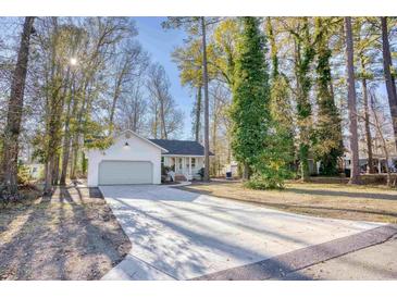 Newly renovated house with a long driveway and mature trees in front at 2409 Causey Dr., North Myrtle Beach, SC 29582