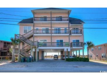 Three-story beach home with multiple balconies and parking underneath at 5300 Ocean Blvd. N, North Myrtle Beach, SC 29582