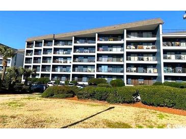 Exterior view of a multi-story building with balconies and landscaping at 5905 S Kings Hwy. # B130, Myrtle Beach, SC 29575
